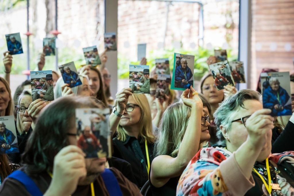 A group of people holding up picture