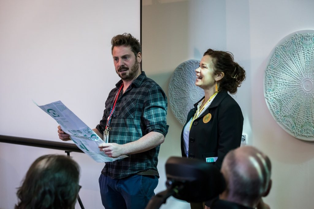 A person and person standing in front of a crowd
