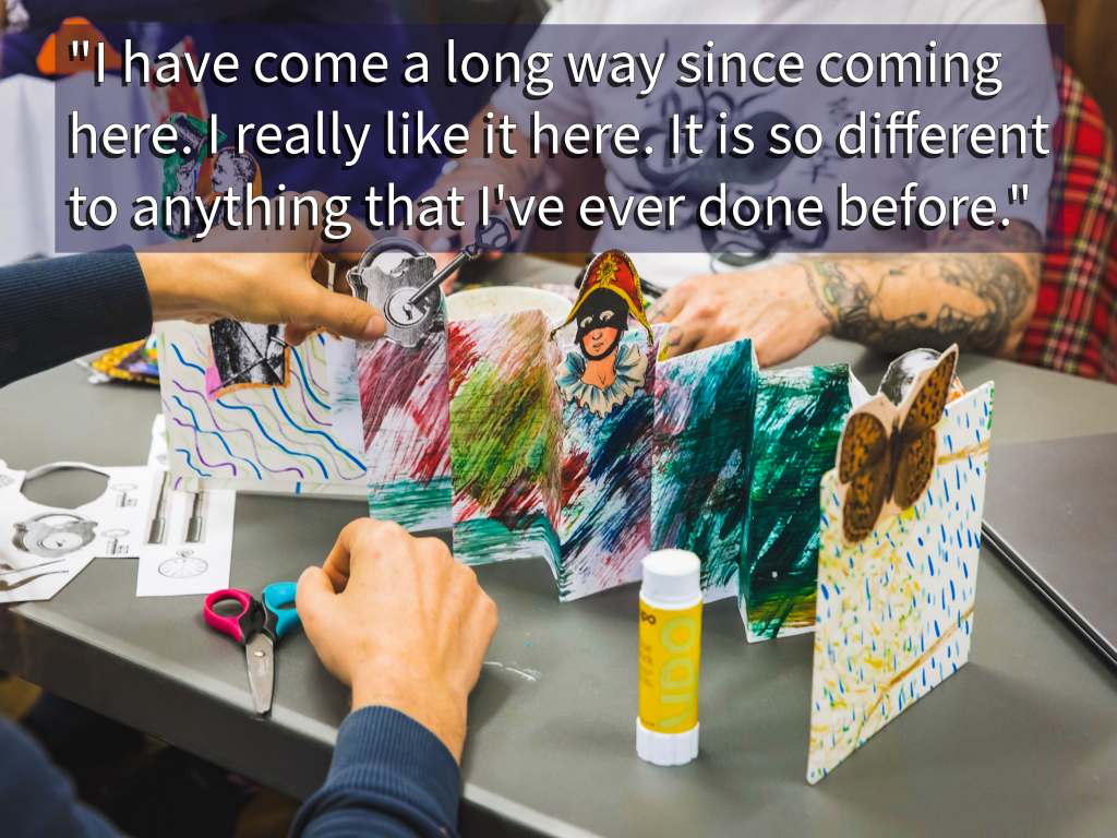 A table with arts and crafts laid out on it.