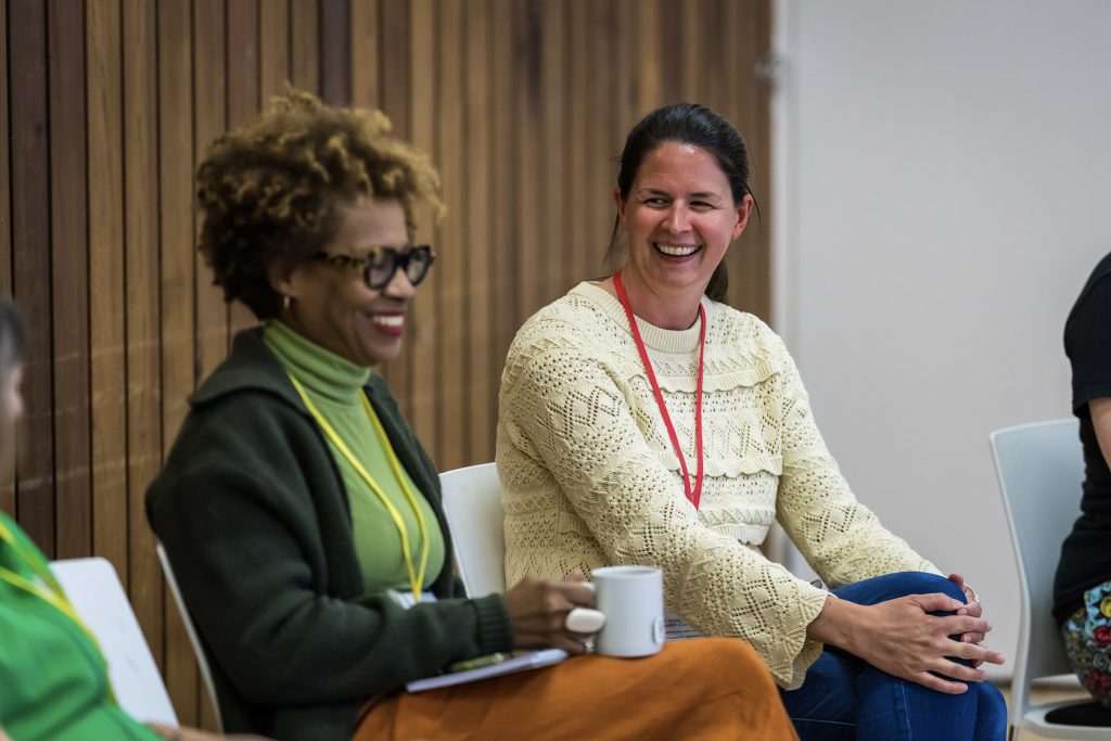Two people talking and smiling at an event