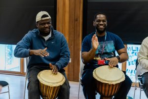 Two men drumming at an event